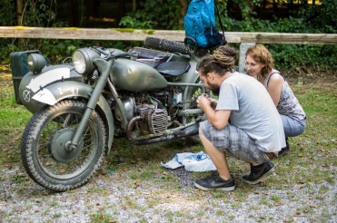 Hungarian Couple, checking an old Russian Ural Motorcycle (Austria)